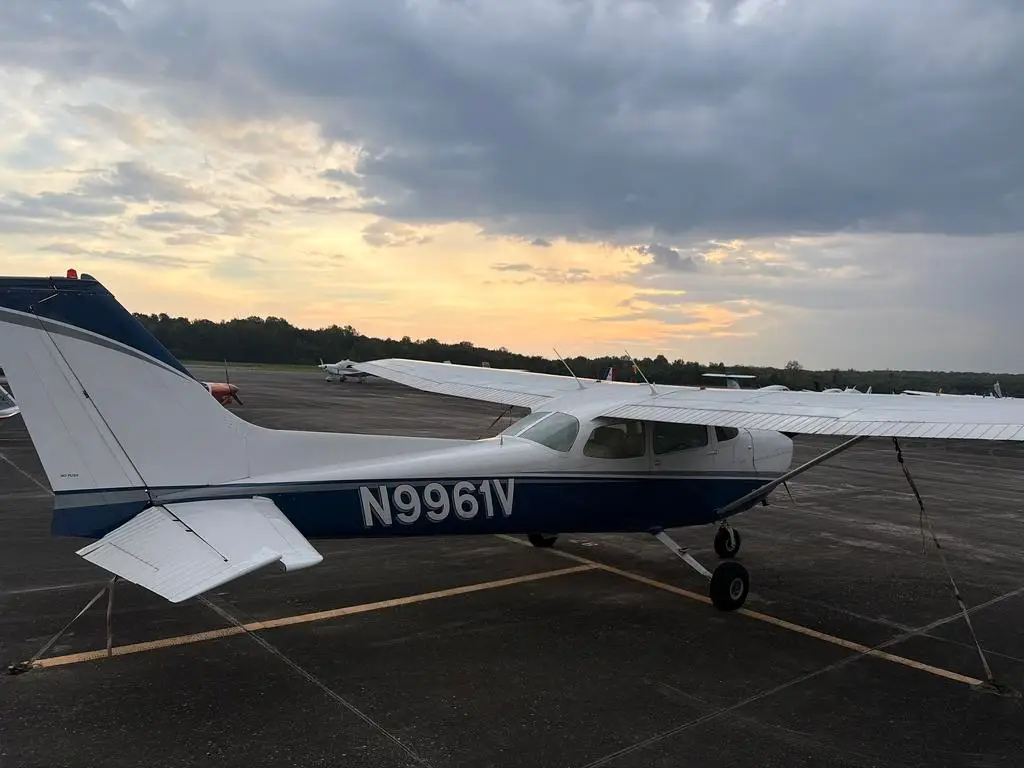 Cessna 172 from the Solid Ground Aviation fleet parked on the ramp at sunset