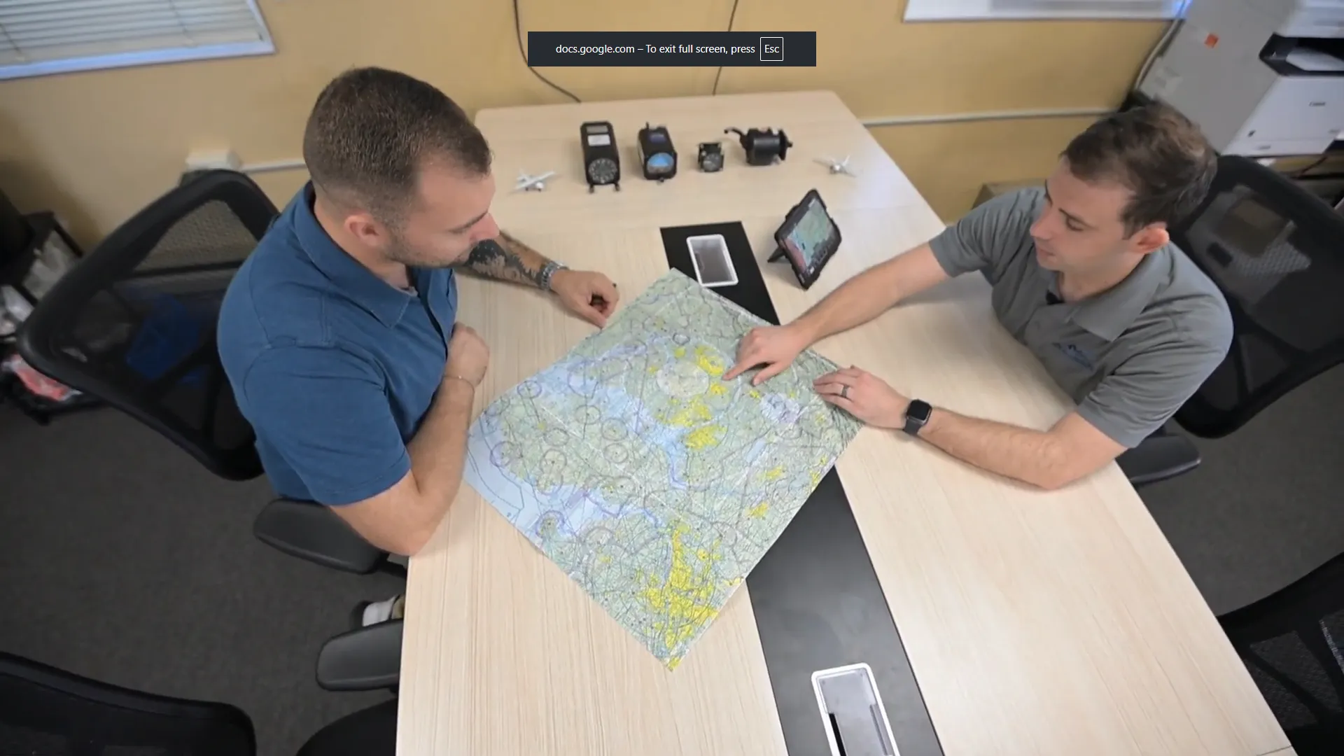 Flight instructor explaining a chart to a student at Solid Ground Aviation