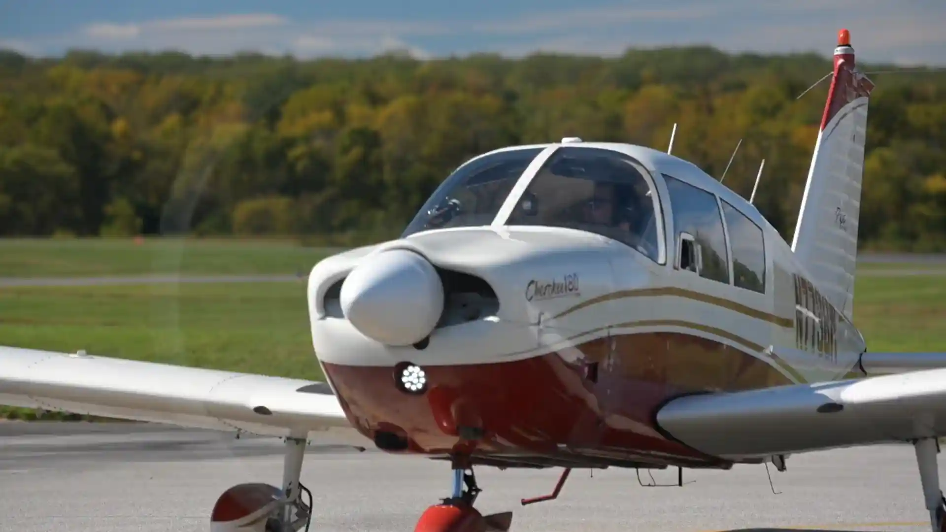 Training aircraft taking off, front view