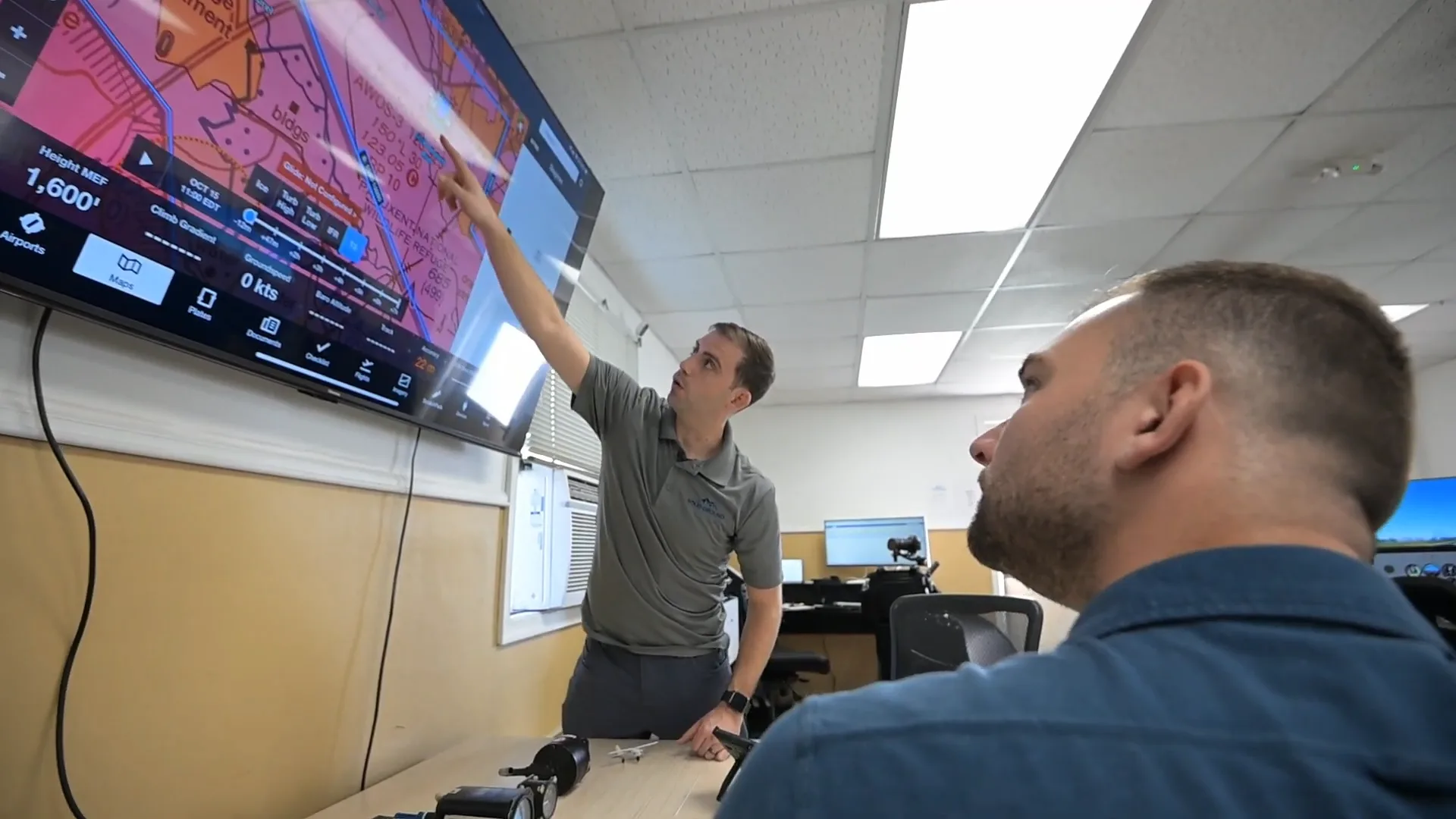Instructor explaining instrument charts to a student