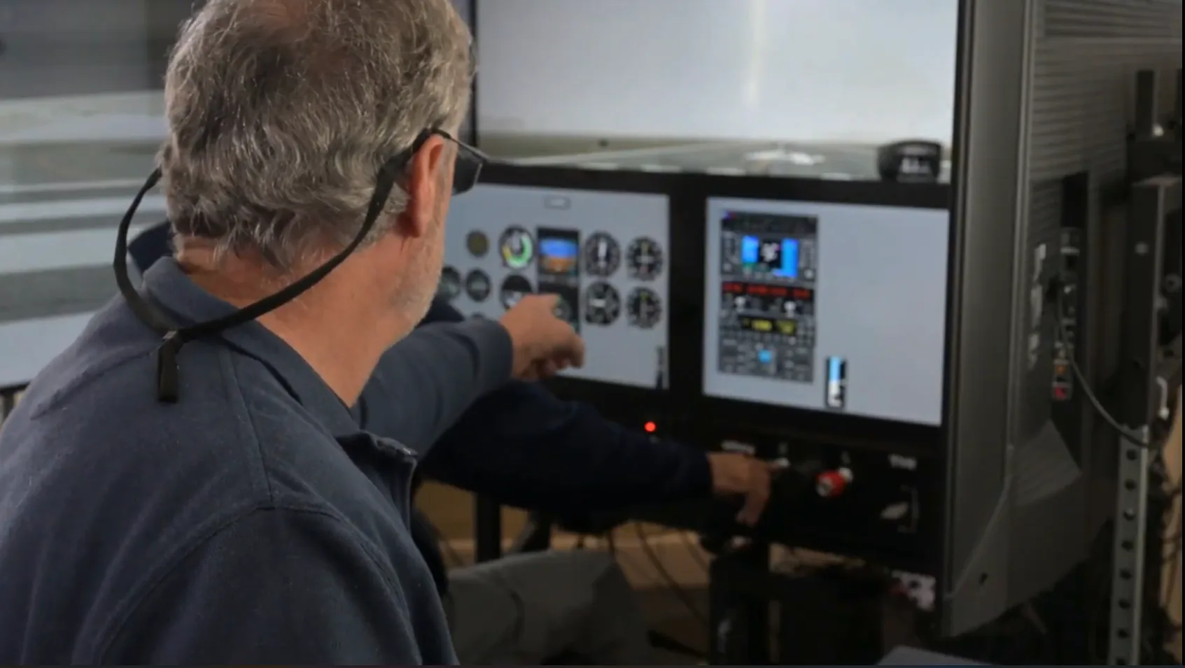 Instructor reviewing an instrument scenario with a student at the simulator